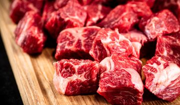 Cut up beef chunks on a cutting board